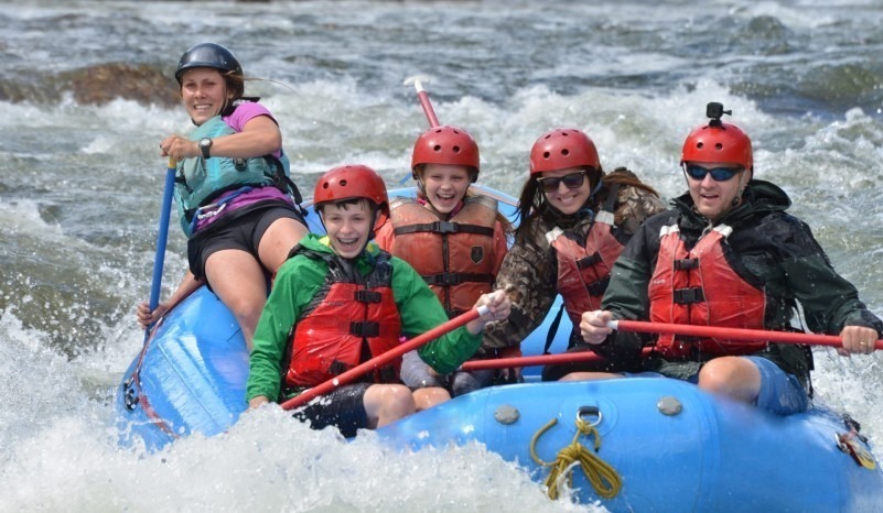  kids enjoying white water river rafting